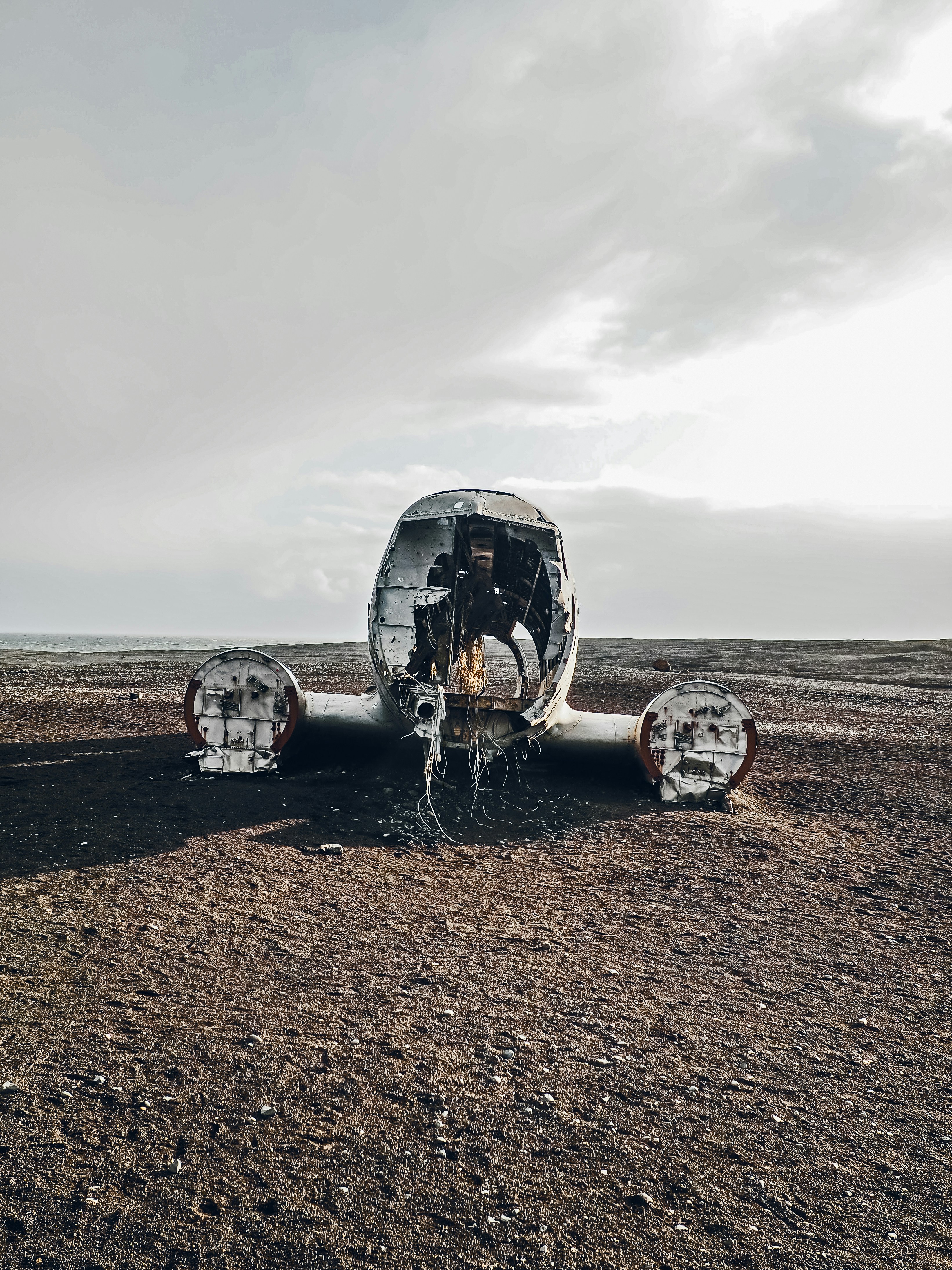a group of metal structures on a dirt field