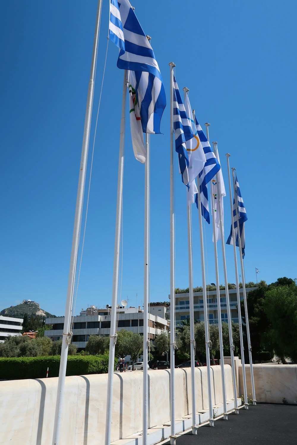 a row of flags on poles