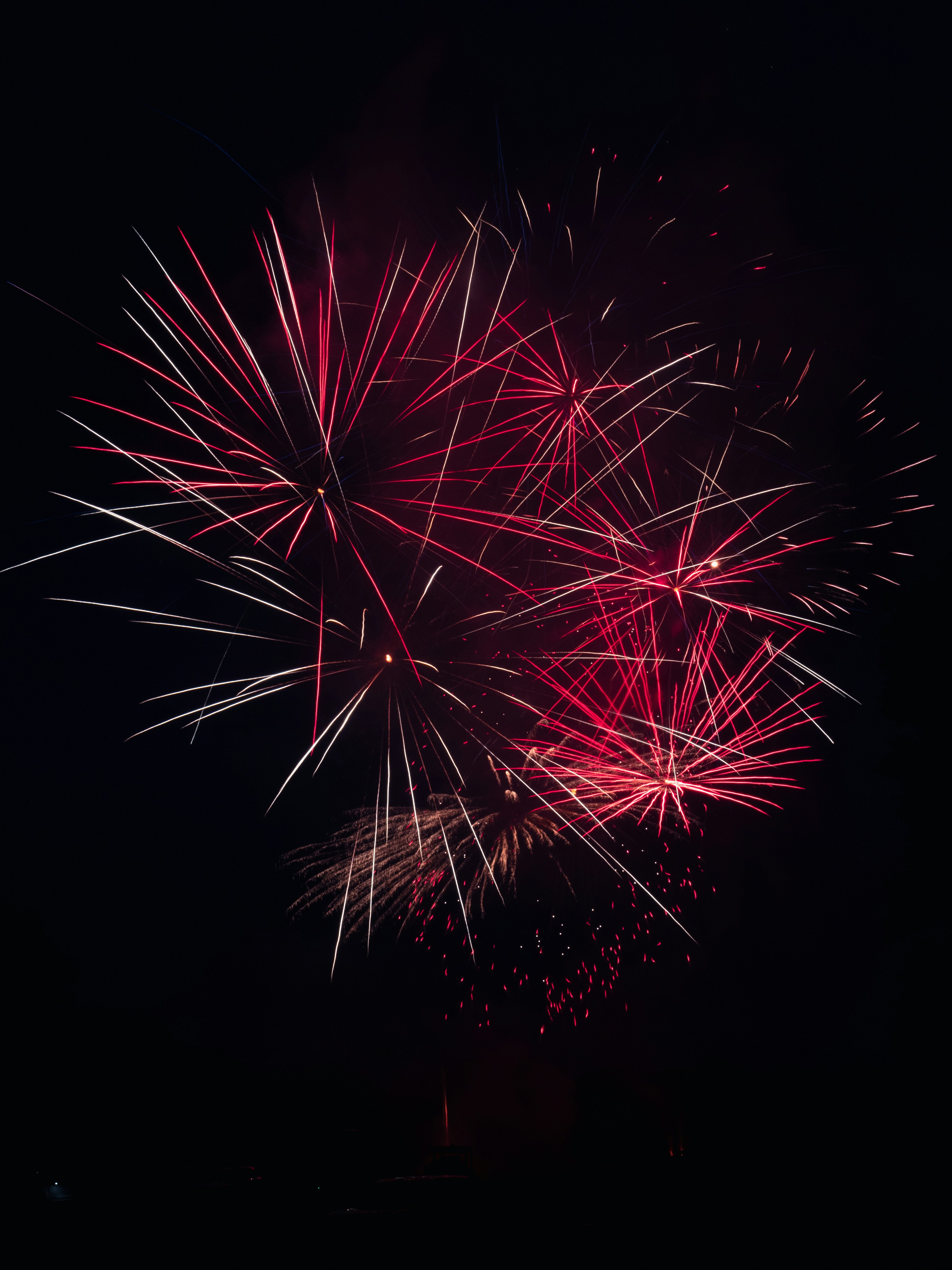 red and white fireworks in the sky