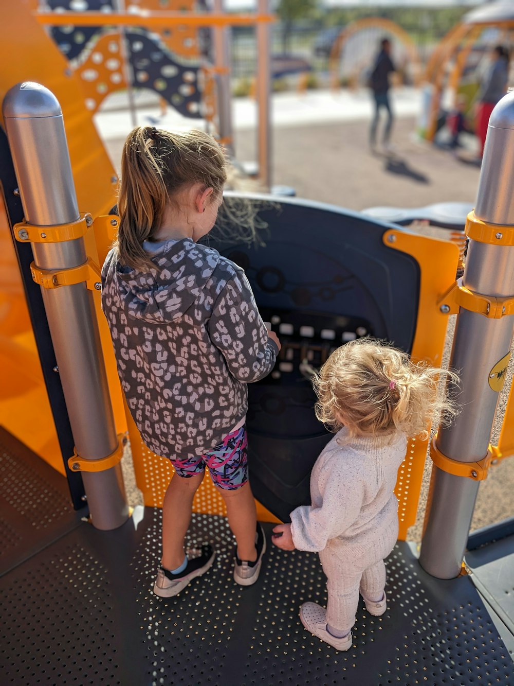 a person and a little girl playing on a playground