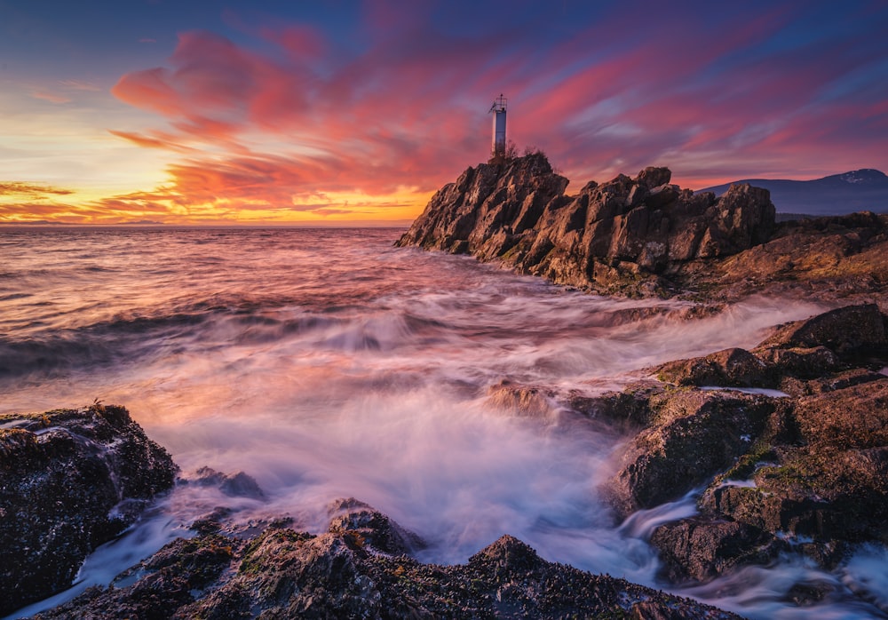 a lighthouse on a rocky cliff