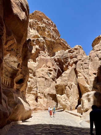 people walking in a canyon