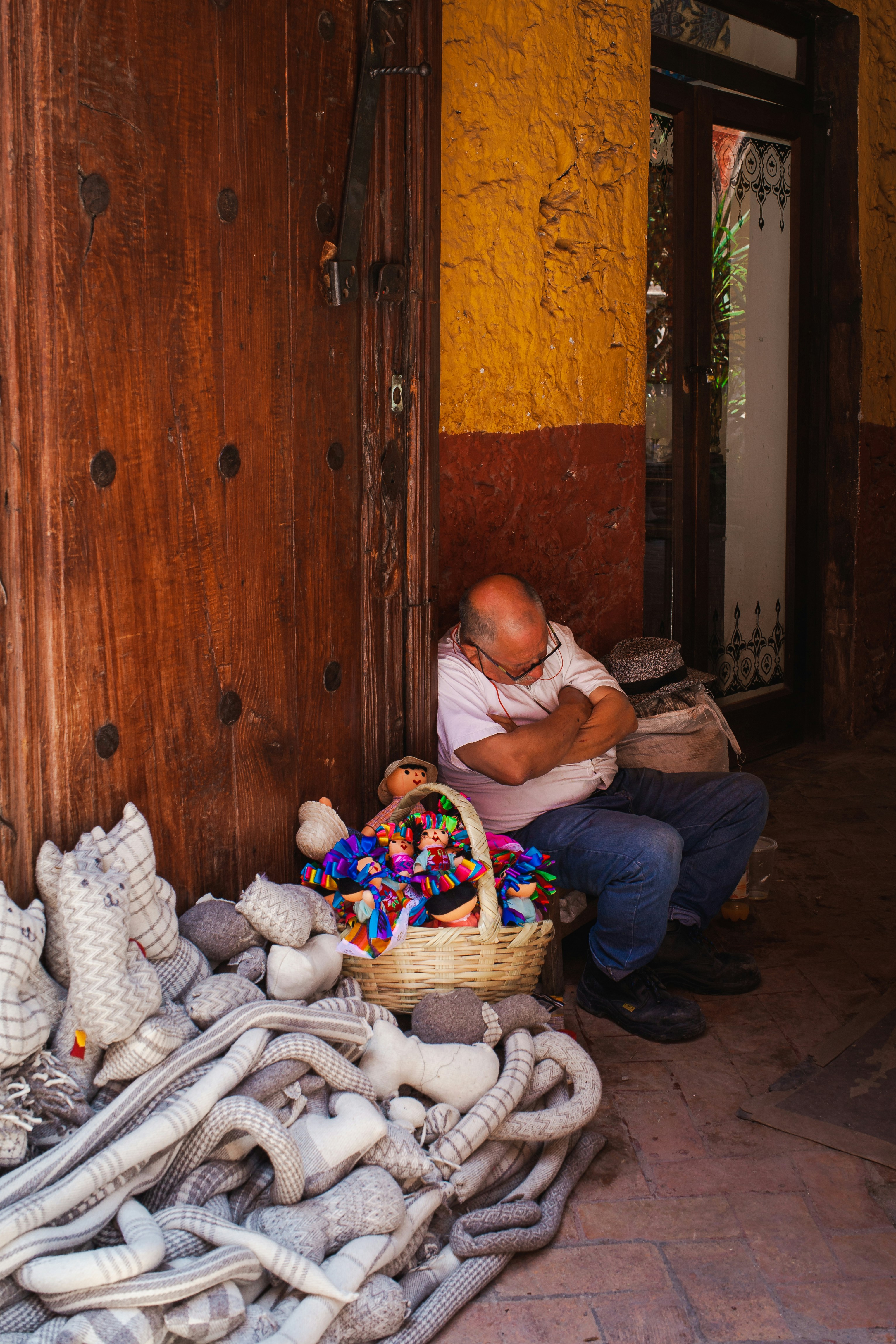 a person sitting on a chair with a basket of stuffed animals