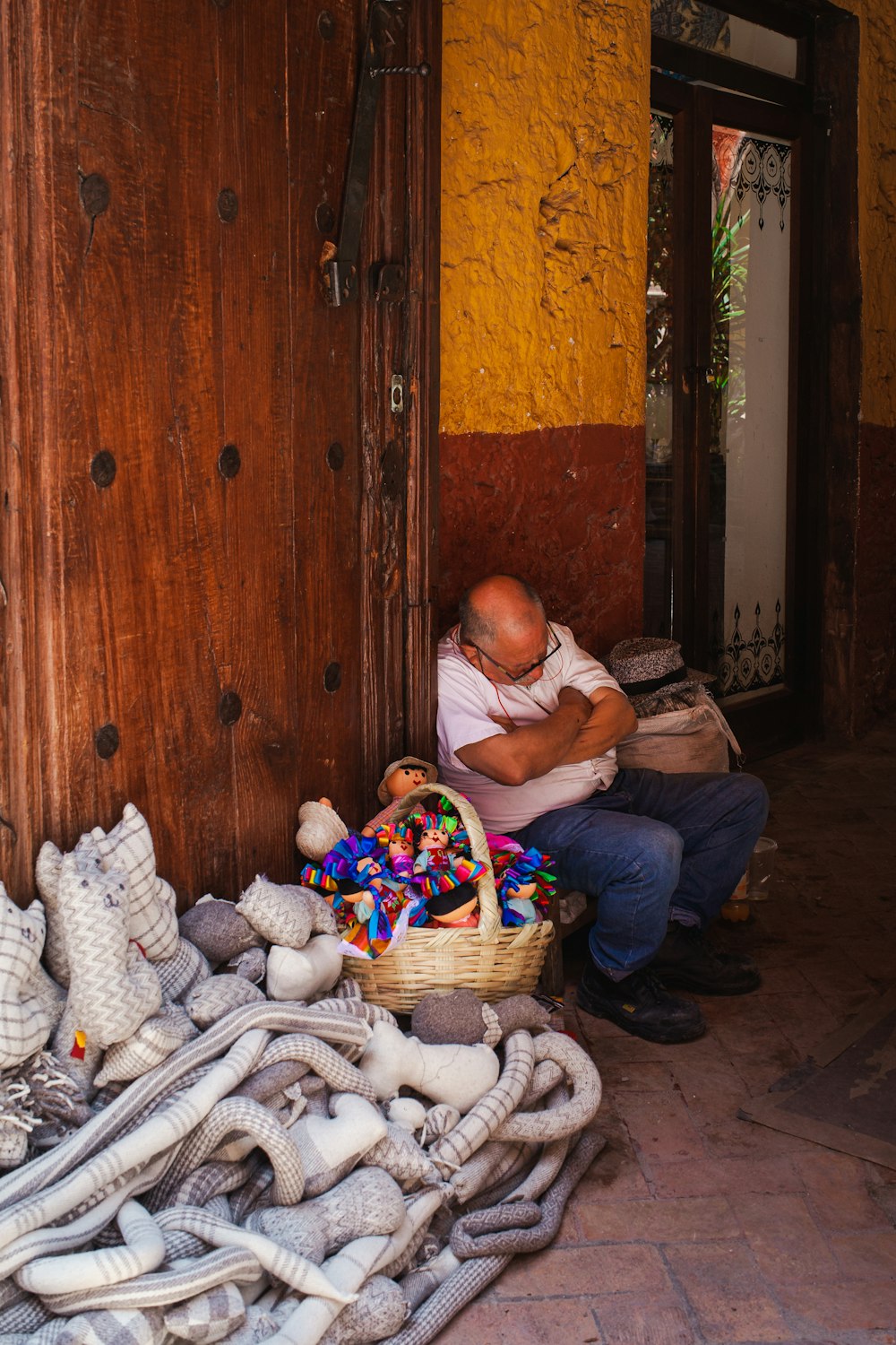 a person sitting on a chair with a basket of stuffed animals
