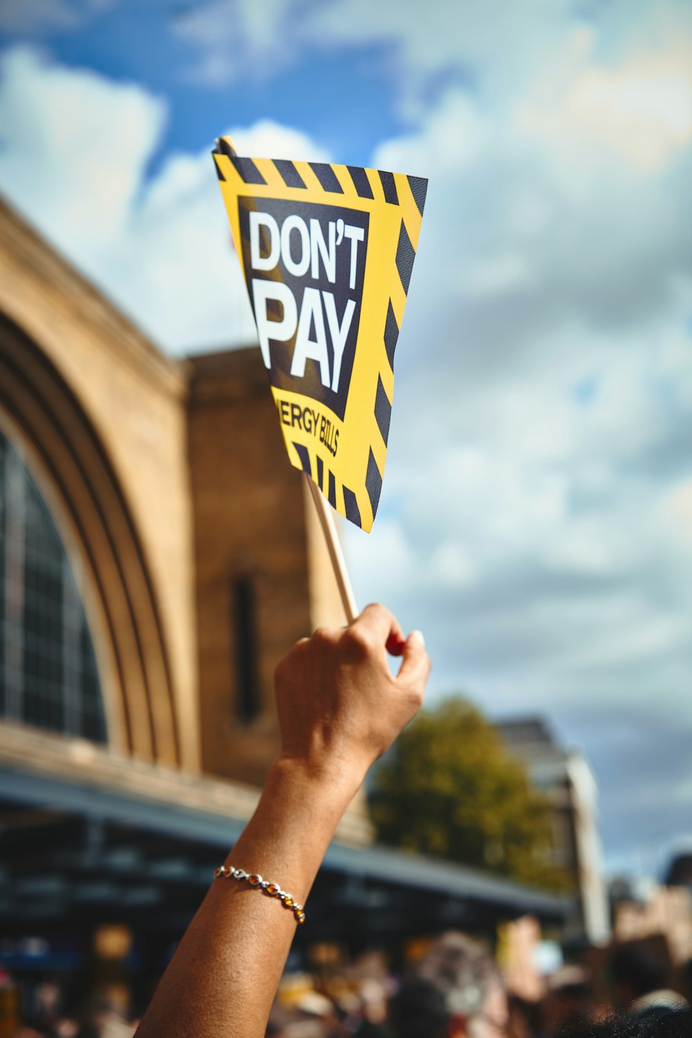 a hand holding a sign