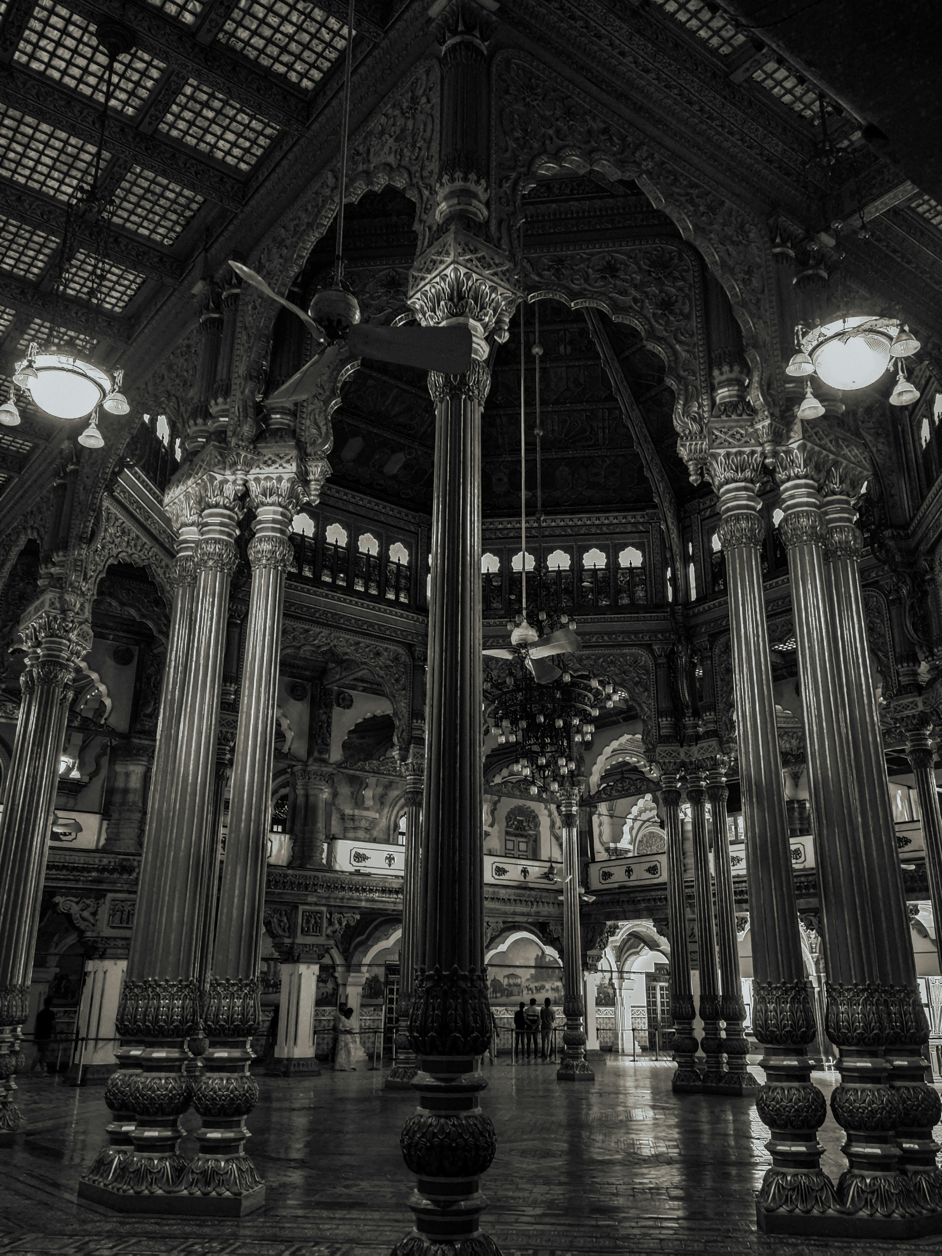 a large room with columns and statues