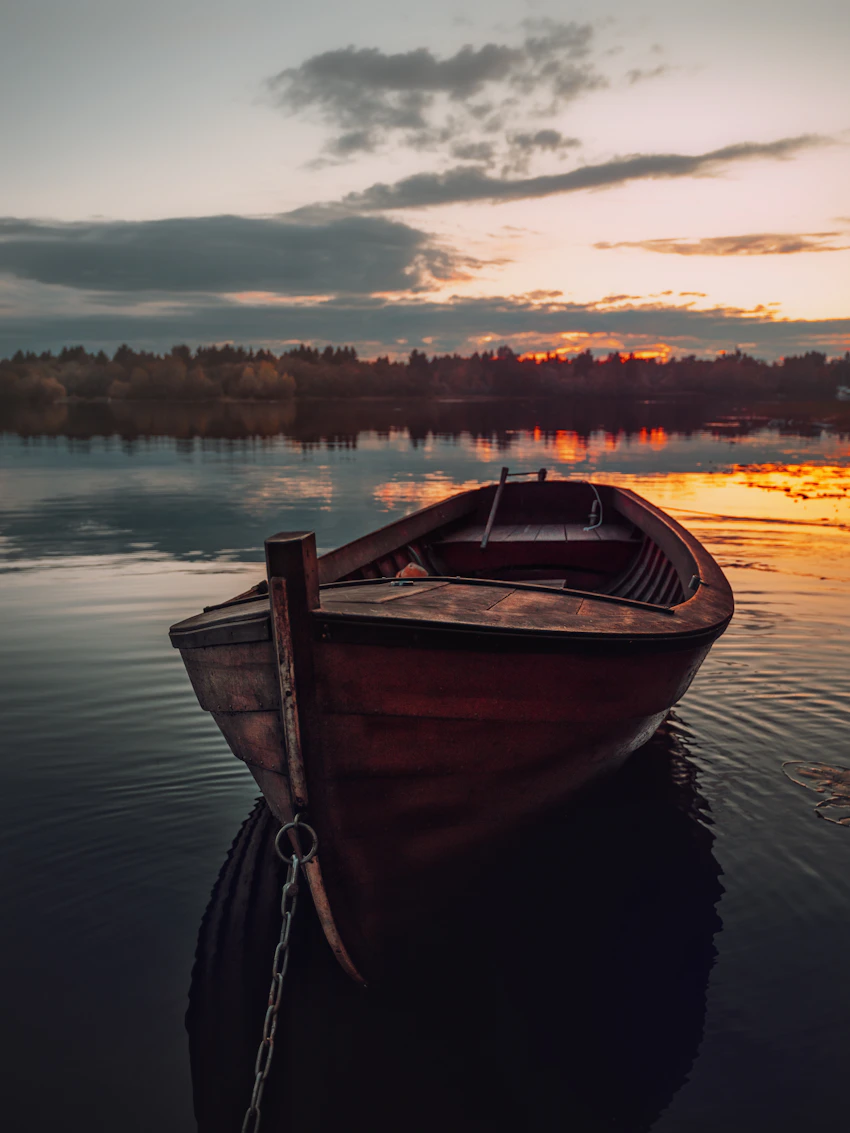 Old wooden boat at sunset in Pikisaari, Oulu
