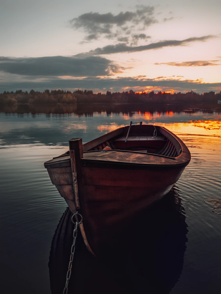 Old wooden boat at sunset in Pikisaari, Oulu