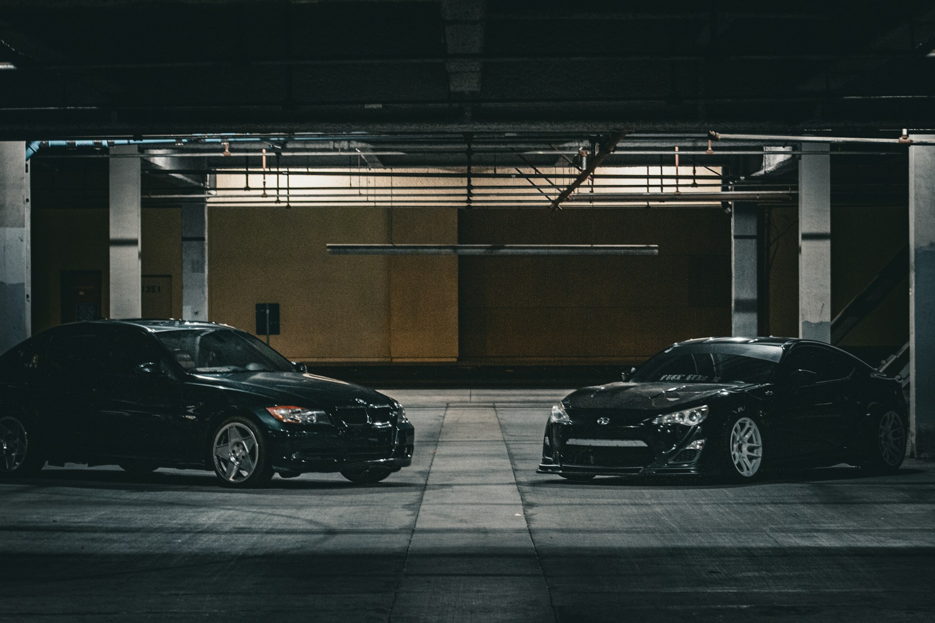 two cars parked in a parking garage