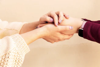 a close-up of hands holding each other