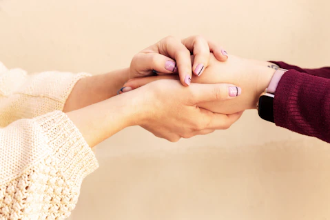 a close-up of hands holding each other