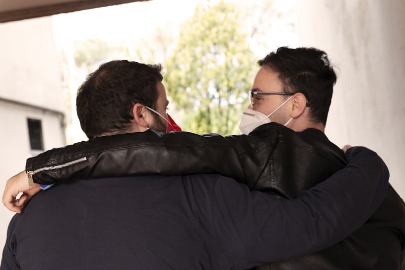 two men wearing black jackets