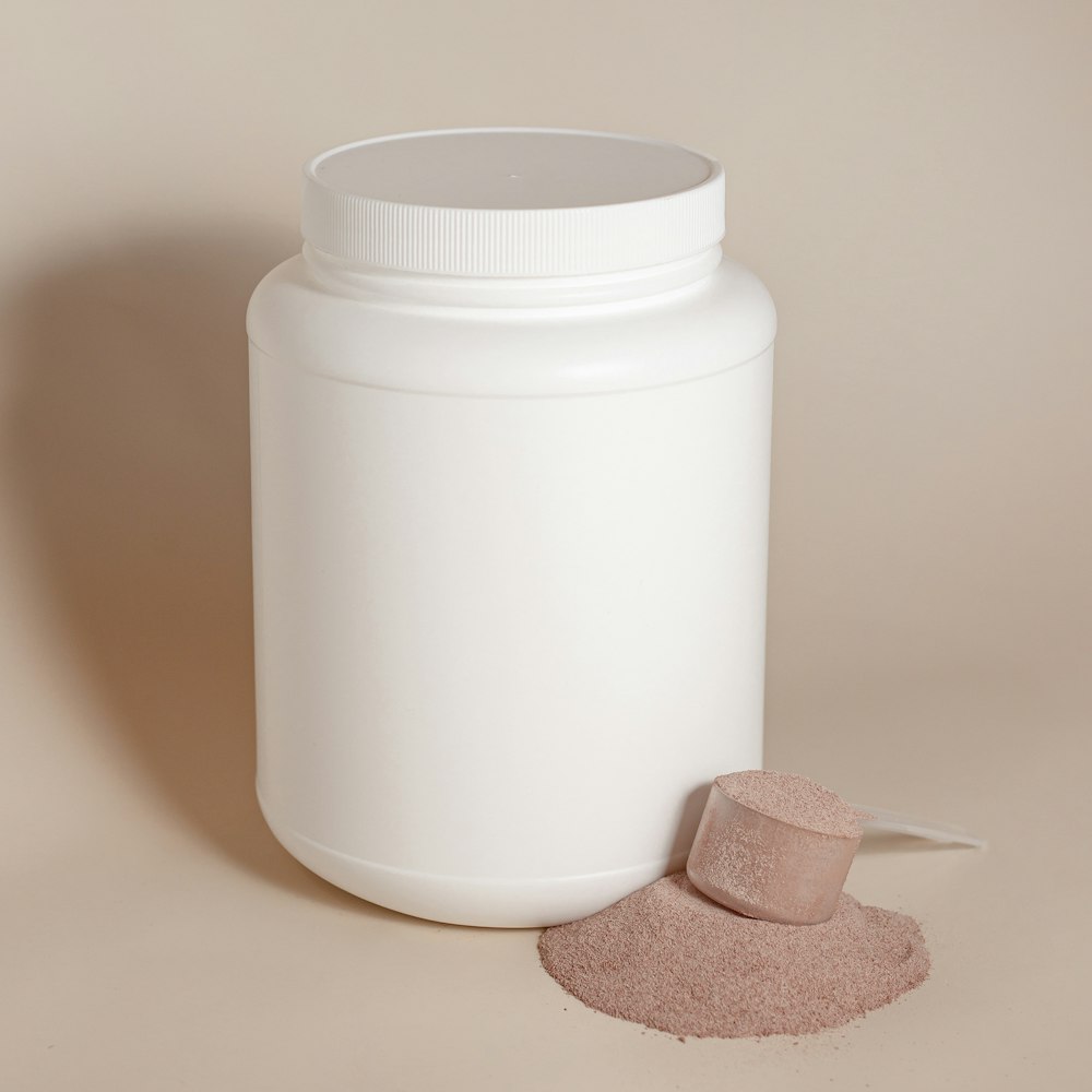 a white cylindrical container with a lid