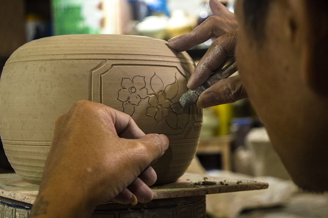 Pottery artisan shaping clay at a traditional workshop
