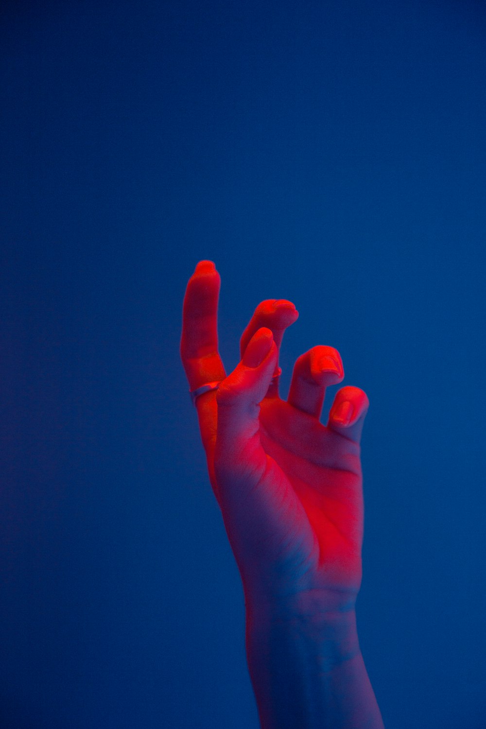 a person's hand with a blue background