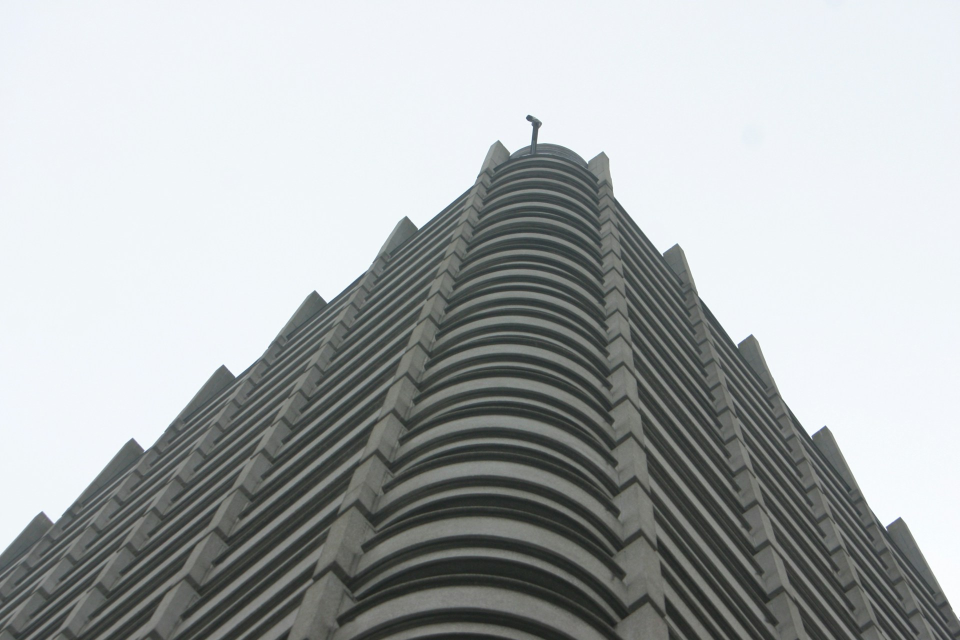 a tall building with a bird on top with Chrysler Building in the background