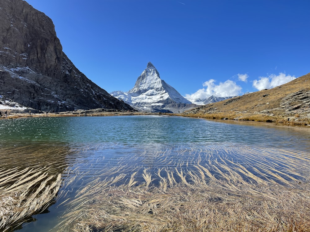 a body of water with mountains in the background