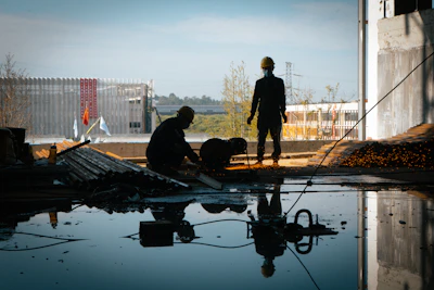 a few men working on a building