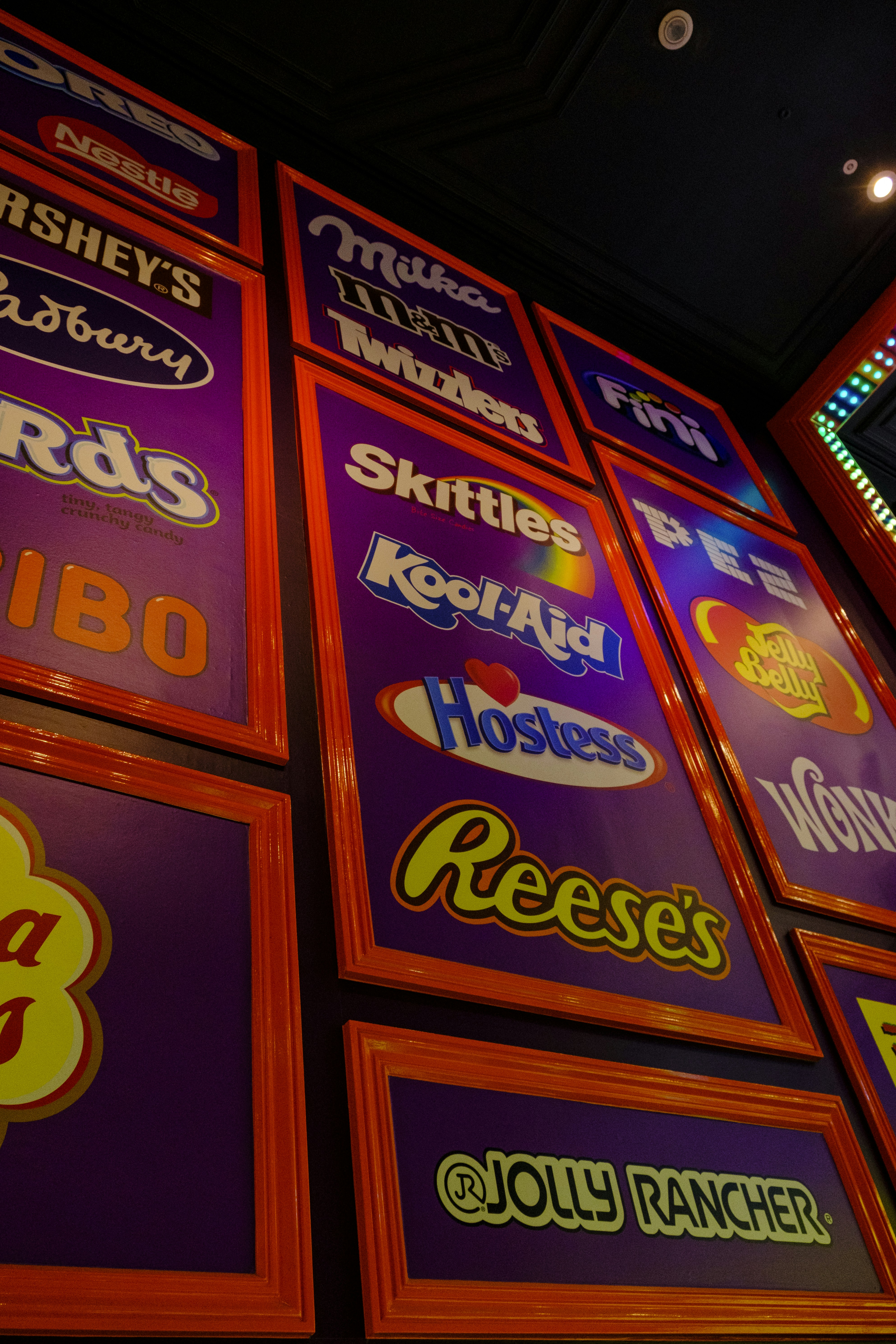 Sweet shop wall with candies and chocolate brands