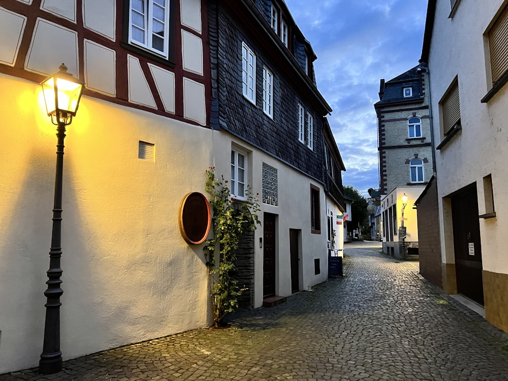 a cobblestone street with buildings on both sides