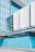 A modern building with large glass windows and sleek architectural design. The lower section features a bright blue facade with the words 'Gallery St' visible. The structure has a contemporary and clean appearance.