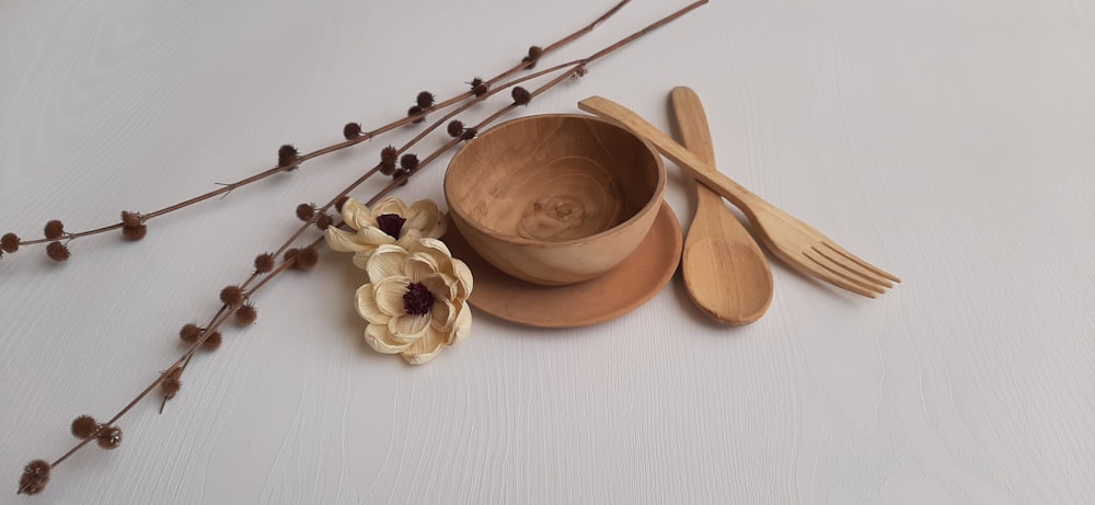 a bowl of flowers and a spoon