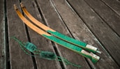 Close-up of handcrafted traditional archery equipment displayed on a wooden table.