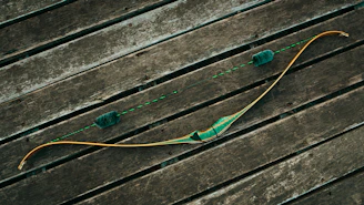 A close-up of a traditional wooden bow with an arrow nocked, ready to shoot.