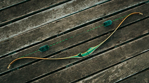 A close-up of a traditional wooden bow with an arrow nocked, ready to shoot.