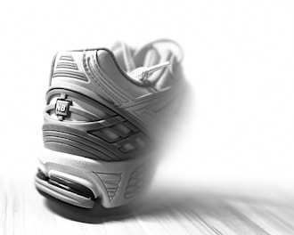 Close-up of a sleek sports shoe with detailed stitching and cushioned sole, perfect for athletes.