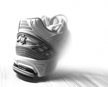 Dynamic close-up of smart technology sports footwear in action on a running track.