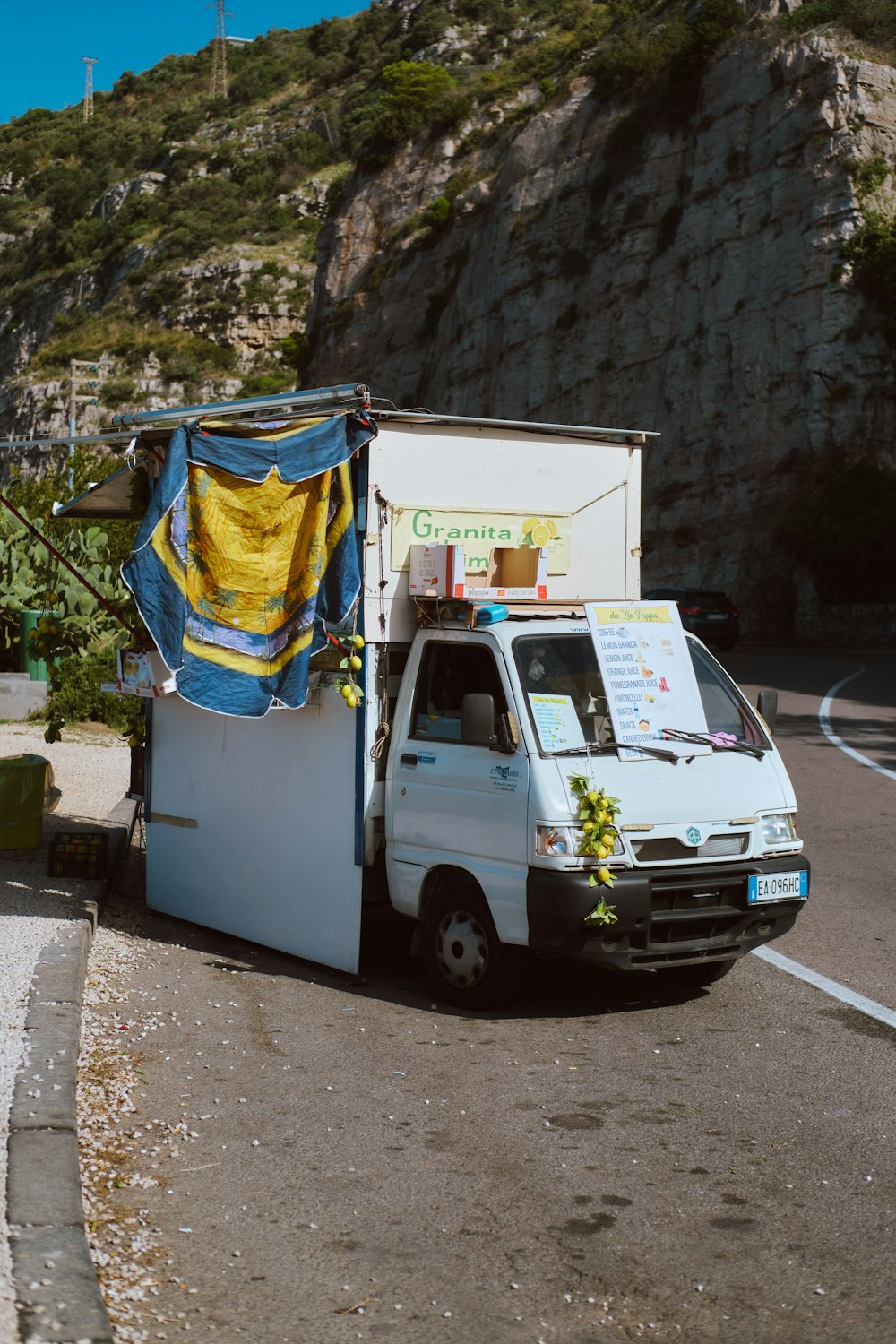 a white van with a blue tarp on top of it