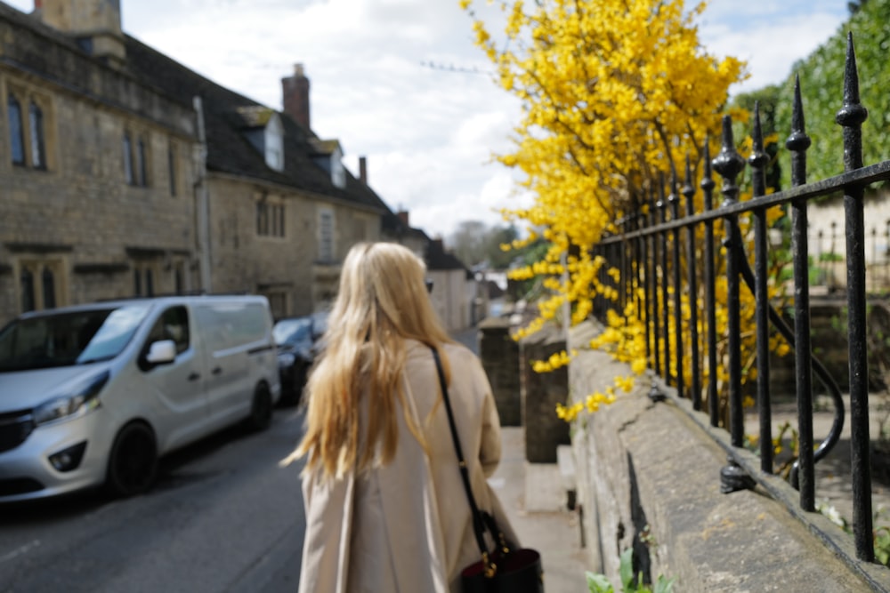 a woman walking on a sidewalk