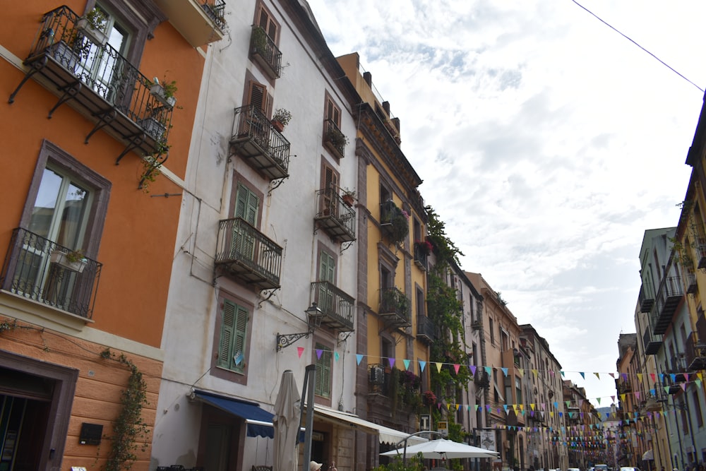 a row of buildings with balconies and a cloudy sky