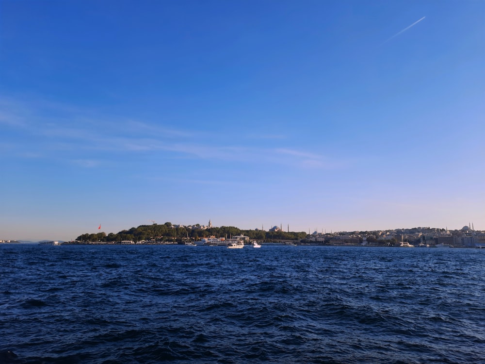 a body of water with a city in the background