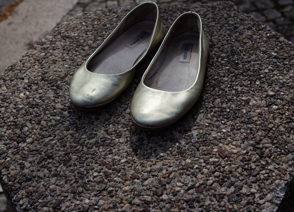 a pair of shoes on a gravel surface