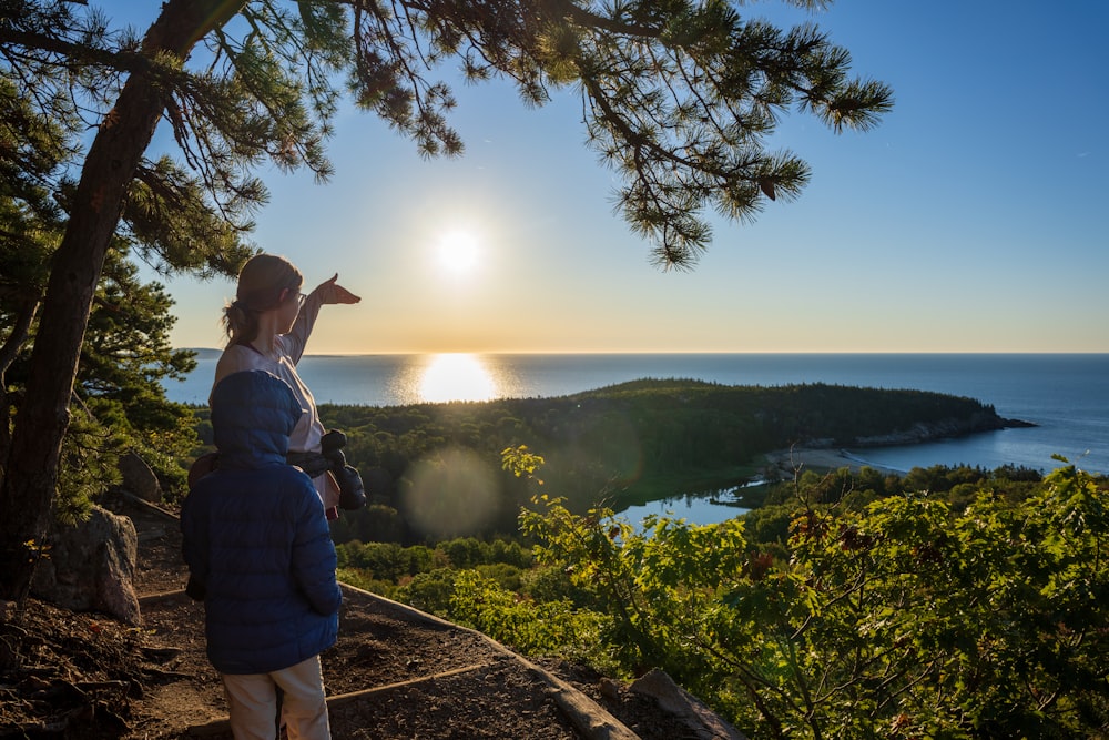 a woman and a man looking at the sun