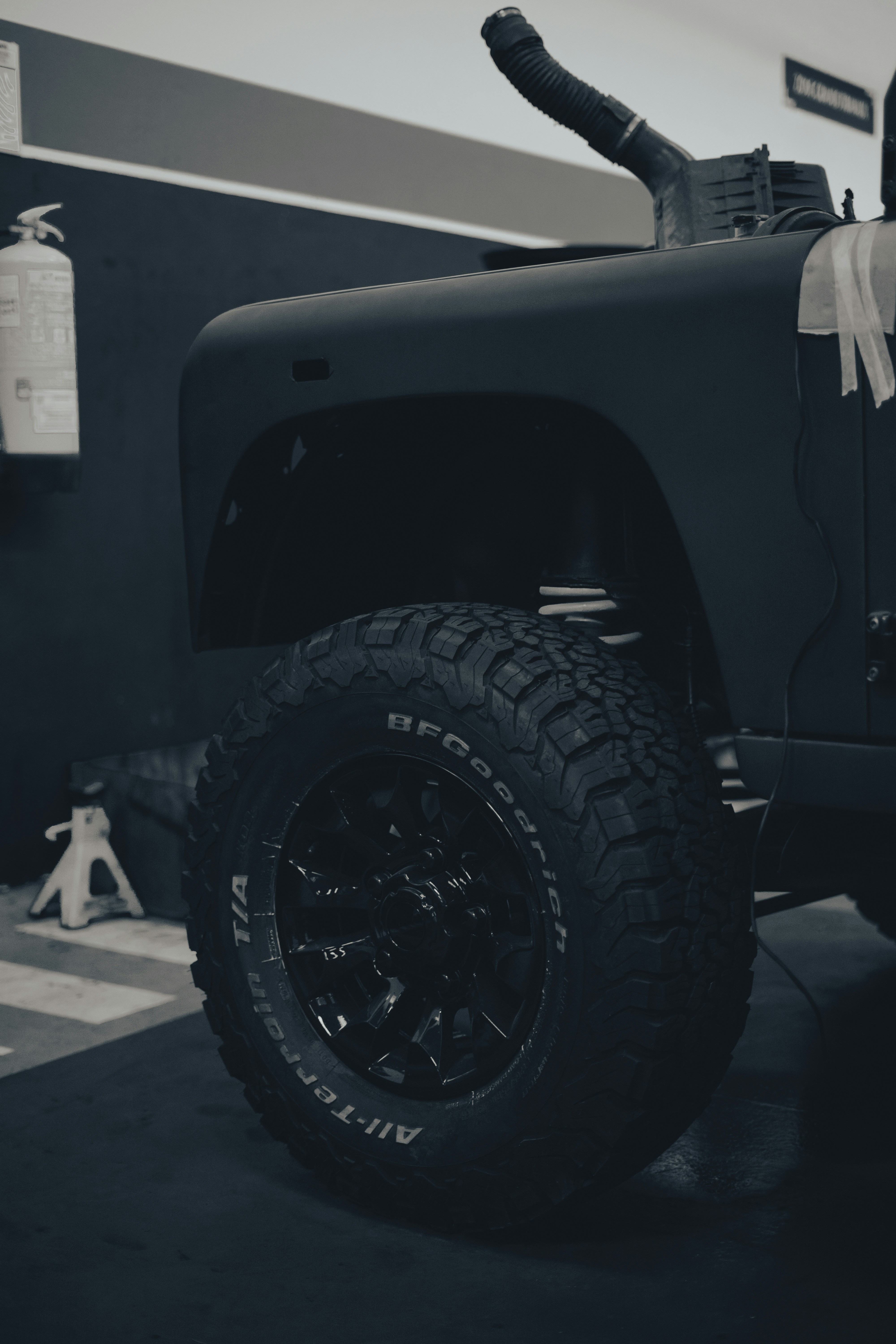 a black car with a large tire