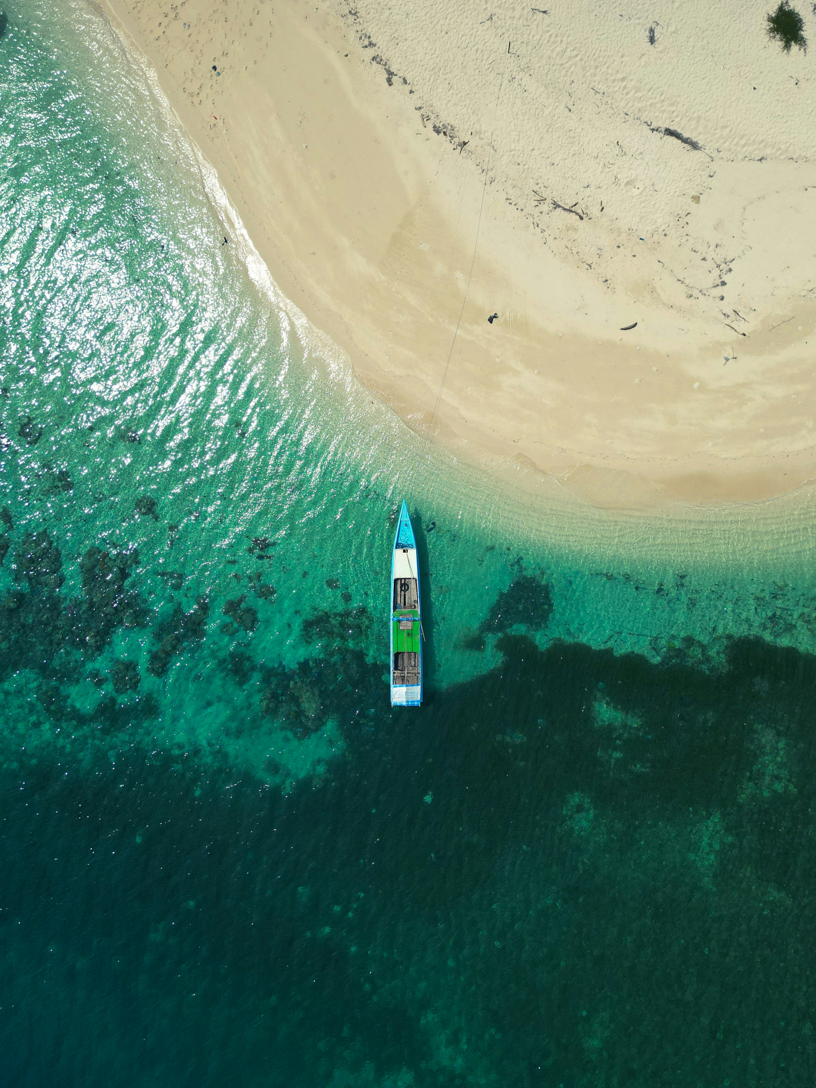 a white and blue rocket on a sandy beach