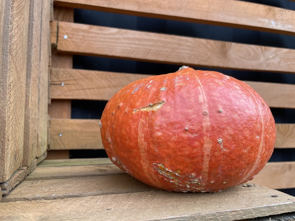 a red apple on a wooden surface