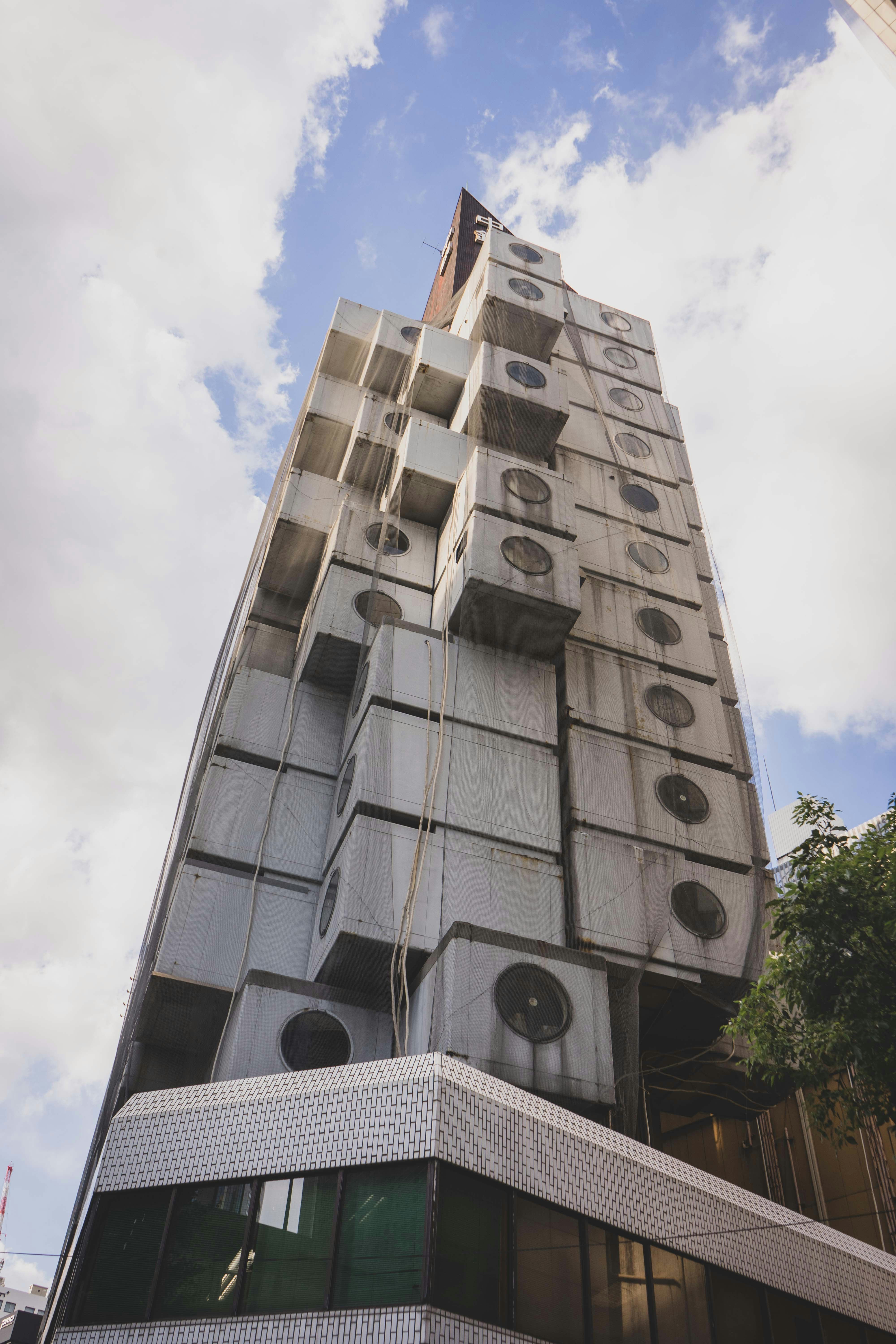 a tall building with a tree in front of it