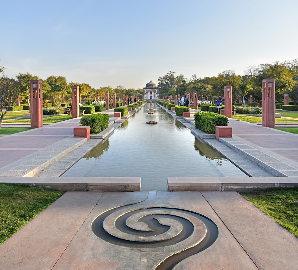 a pond with a fountain in it