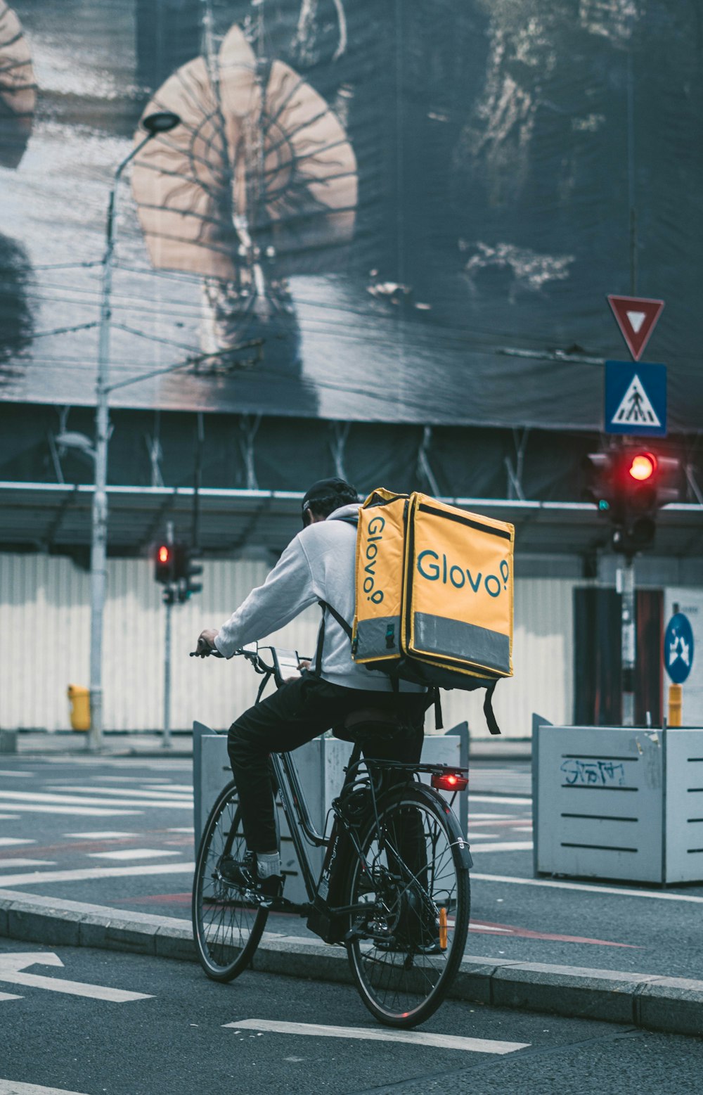 a person riding a bicycle with a bag on the back