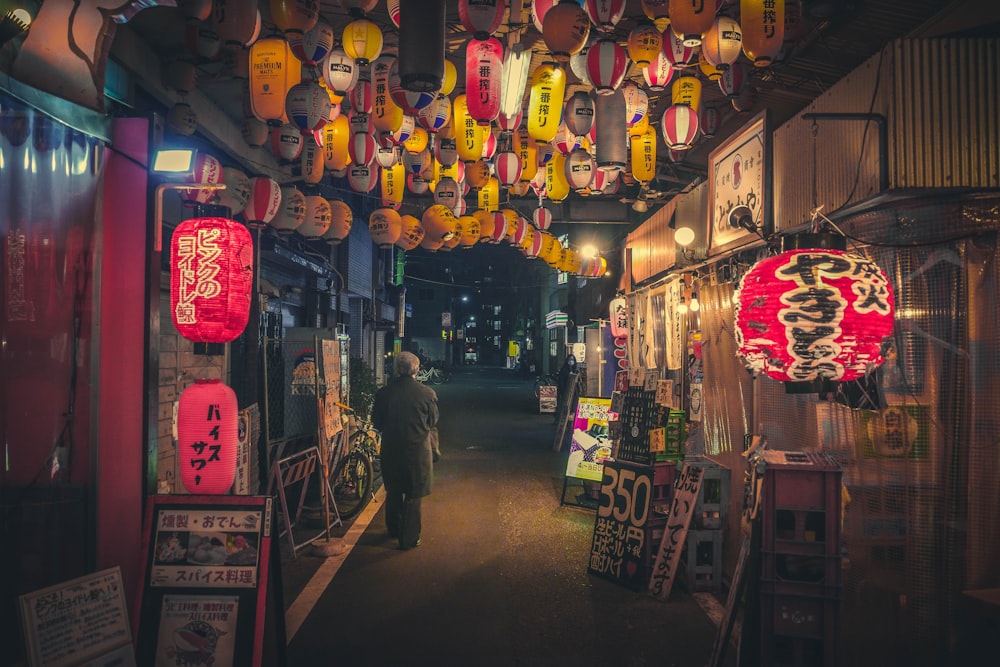 a person walking down a narrow alley