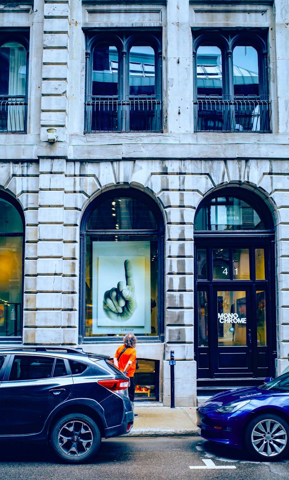 a person standing in front of a building with a large window