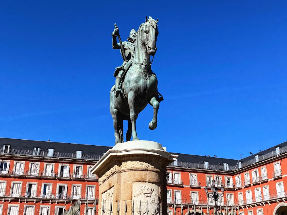 a statue of a person riding a horse