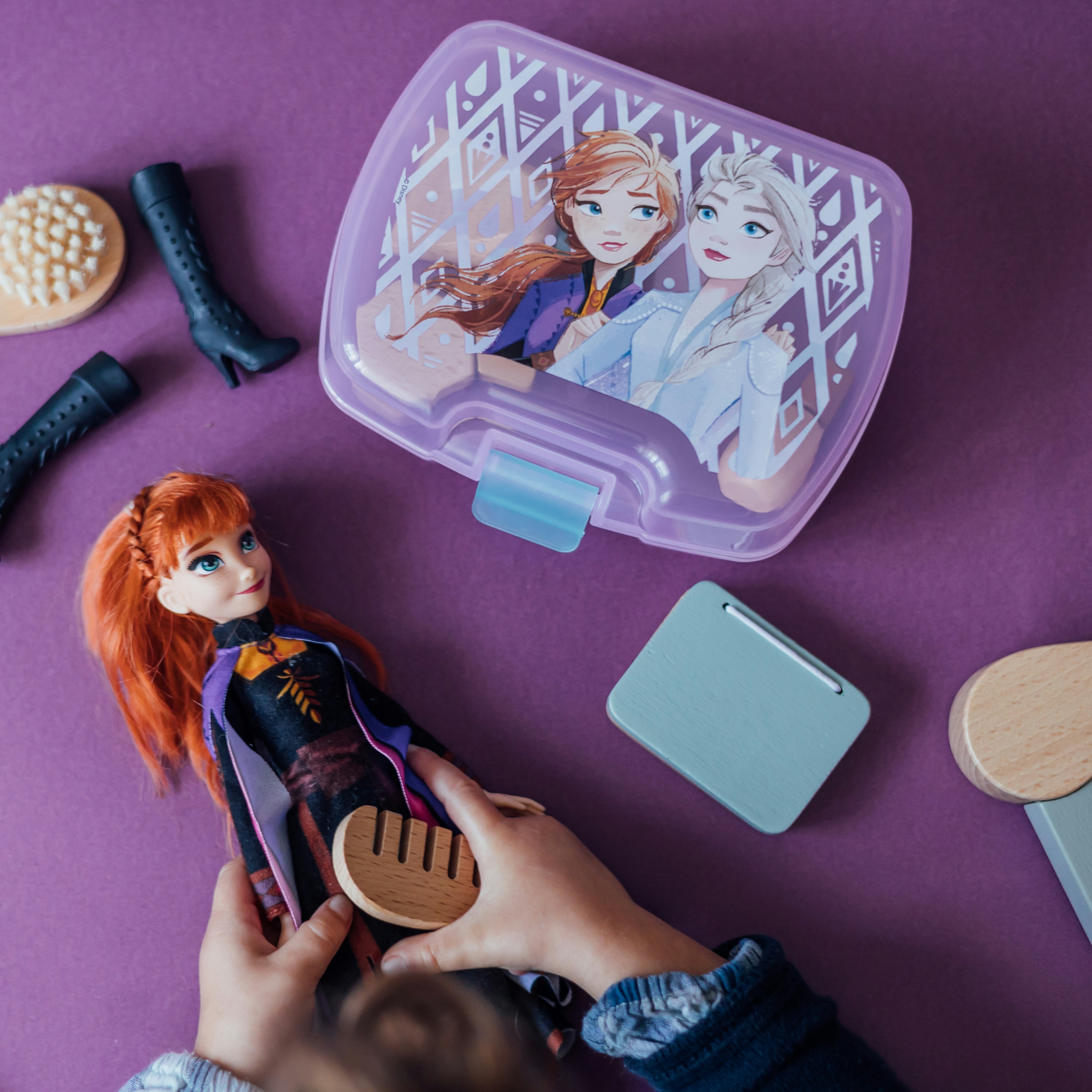 a hand holding a toy figurine next to a toy figurine