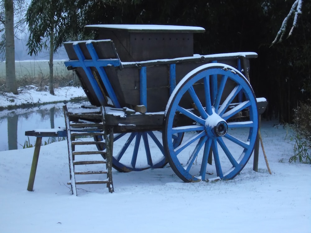 a blue and white wagon in the snow