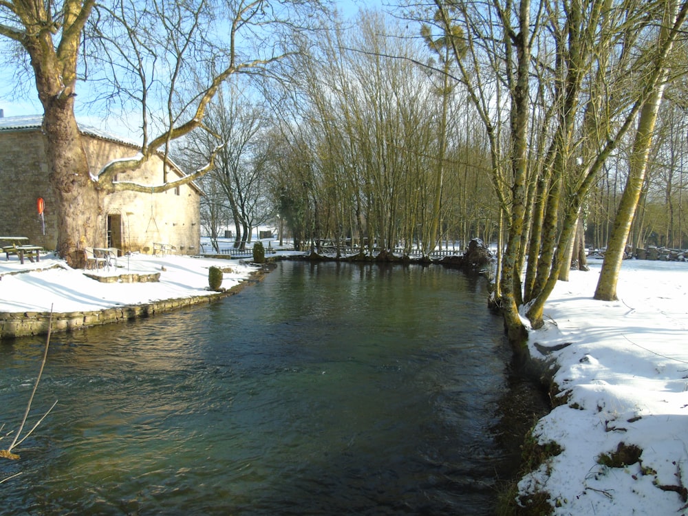 a river with snow on the banks