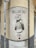 A vintage-style sign is mounted on a corner wall, depicting a woman in traditional attire holding a container. The text on the sign reads 'Mallorcaria' at the top and 'Vins' at the bottom. The sign appears weathered, adding an old-world charm.